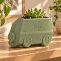 Maceta camioneta retro verde salvia con suculenta en el techo en repisa cálida