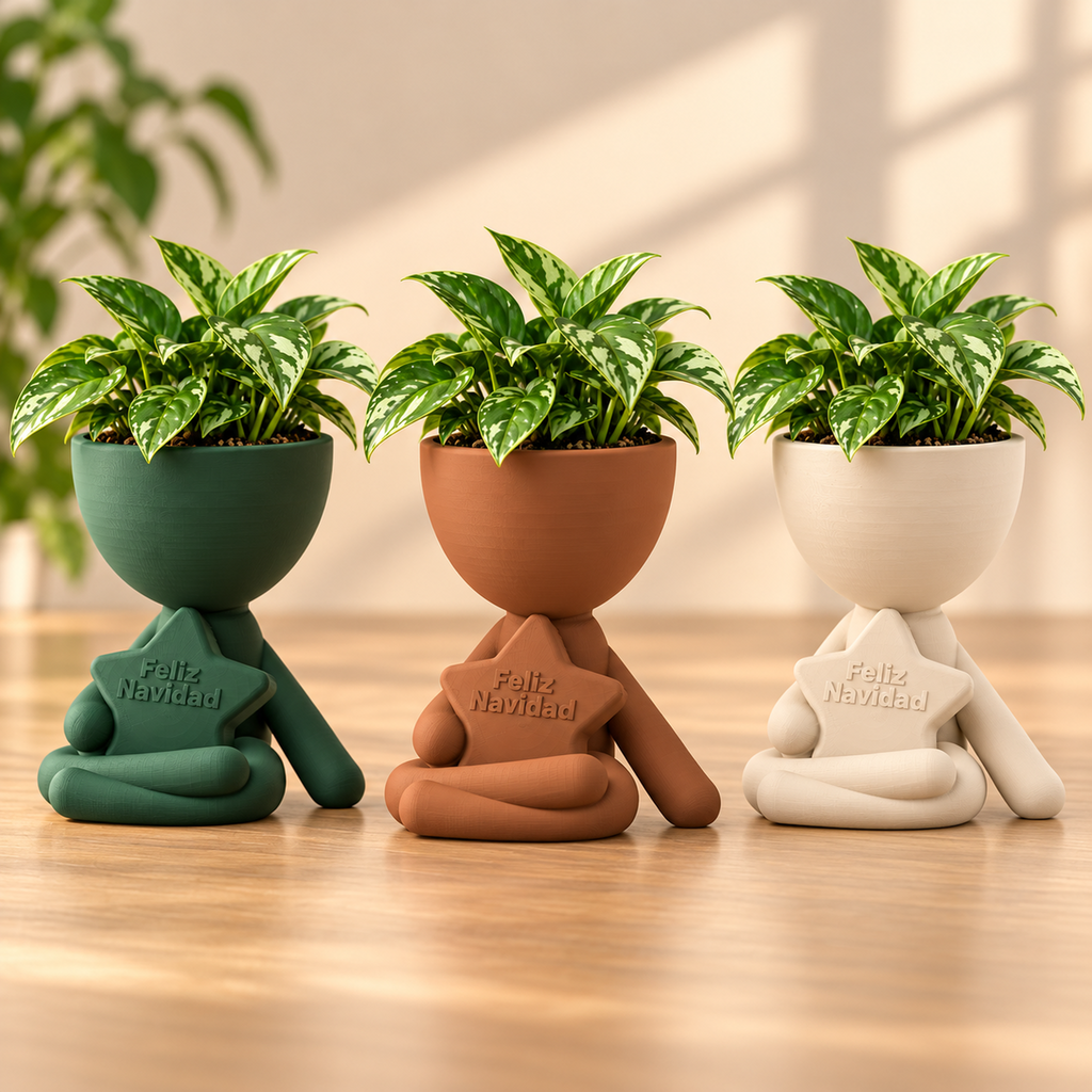 Matera Hombrecito Navideño en verde pino, terracota y marfil con plantas pequeñas.